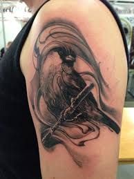 Arm tattoo with black bird