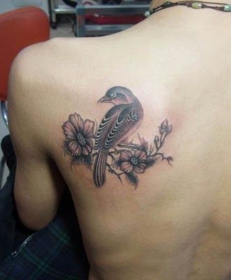 Back tattoo with bird and flowers