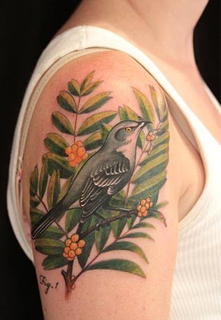 Bird among leafes tattoo