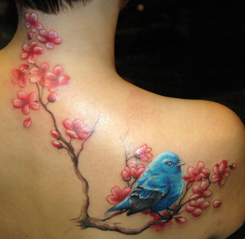 Bird and cherry flowers as tattoo