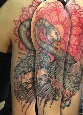 Decorative swan and skull tattoo