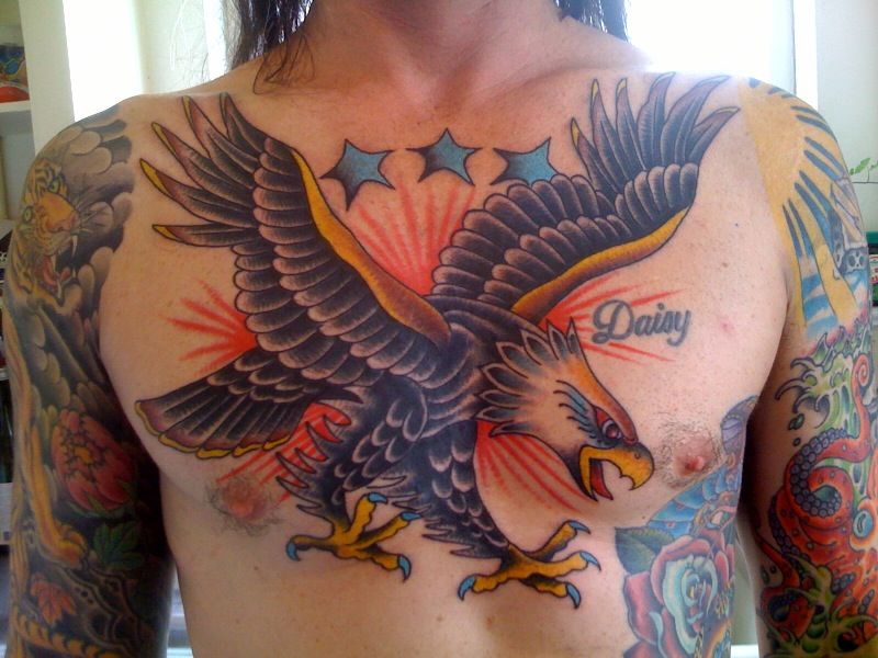 Tattoo with eagle in black and gold colours