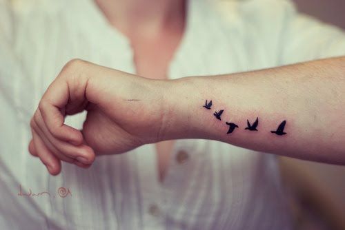 Tattoo with five birds on hand