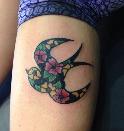 Floral motive swallow tattoo