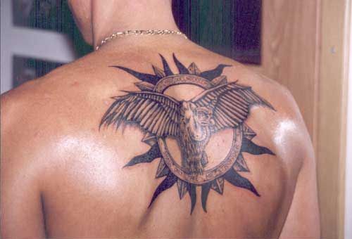 Black bird with circle tattoo