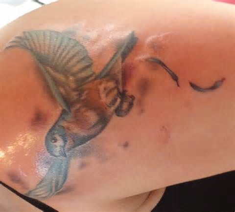 Blue and white dove tattoo