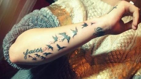 Small birds tat on arm