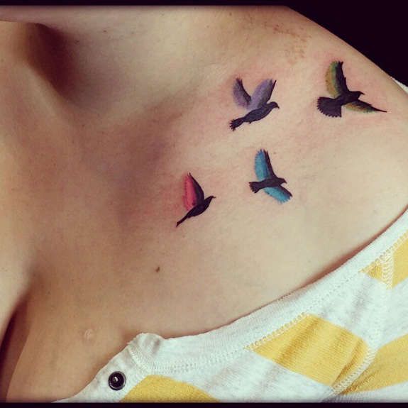 Four small birds on tattoo