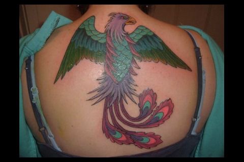 Peacock with big wings tattoo