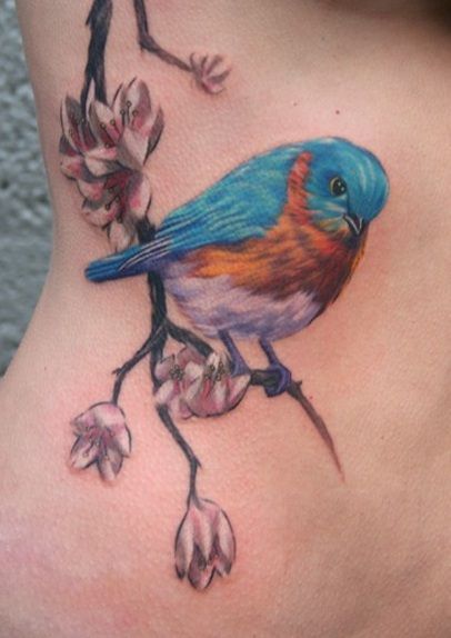 Small bird on branch tattoo