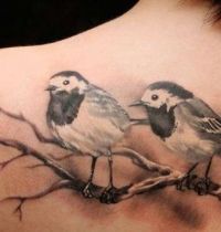 Tattoo with birds sitting on a branch