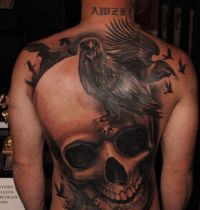 Big skull and black birds tattoo