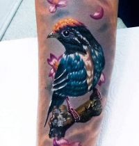 Bird and pink flowers tattoo