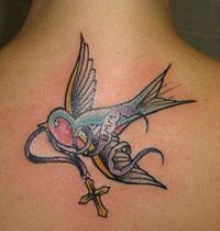 Bird with cross tattoo