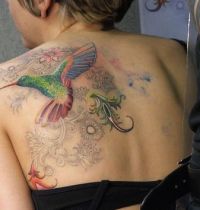Bird with flowers tattoo