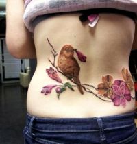 Bird with pink flowers tattoo