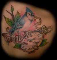 Blue and white bird tattoo