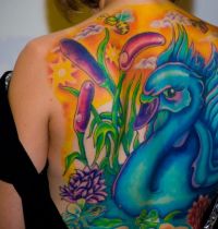 Blue swan back tattoo