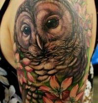 Brown owl and flowers tattoo
