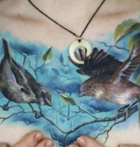 Chest tattoo with birds and flower