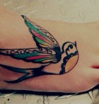 Decorative bird tattoo on foot