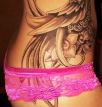 Hip tattoo with peacock bird