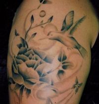 Hummingbird and flowers tattoo
