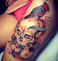 Bird on skull tattoo