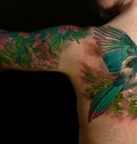 Tattoo of magpie with green wings
