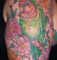 Parrot among flowers tattoo
