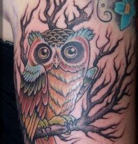 Rainbow owl on tree tattoo