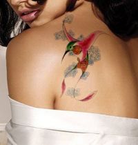Small hummingbird and flower tattoo