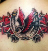 Back tatoo with swallow and horseshoe