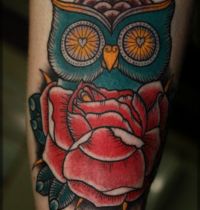 Tattoo of owl and red rose