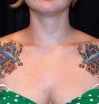 Two blue swallows on tattoo