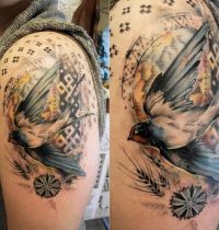 White and grey swallow tattoo