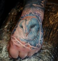 White owl hand tattoo