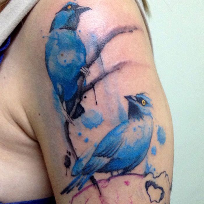 Two birds in blue colour tattoo