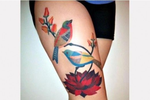 Two birds with flowers tattoo