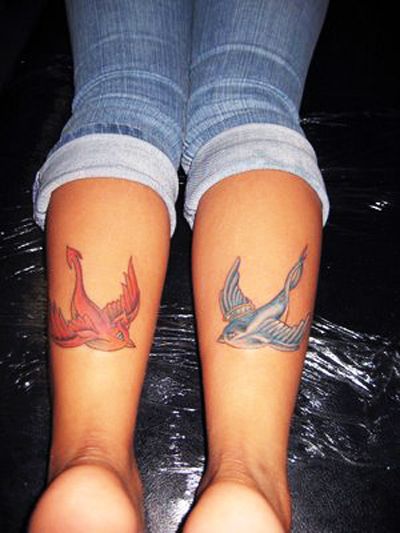 Two swallow tattoo on calfs