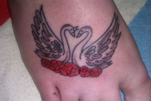 Tattoo with two swans and roses