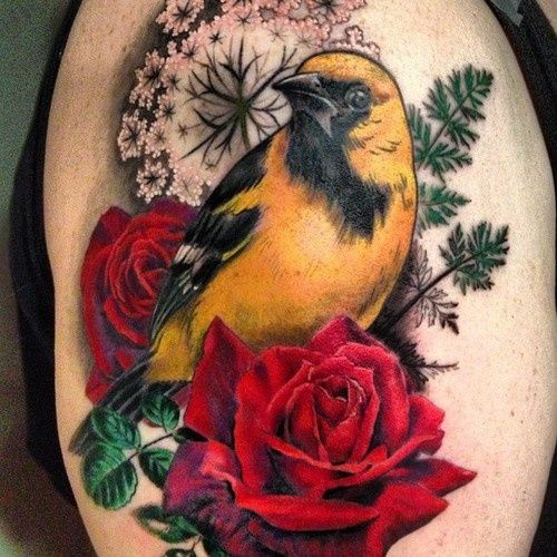 Yellow bird with red roses tattoo